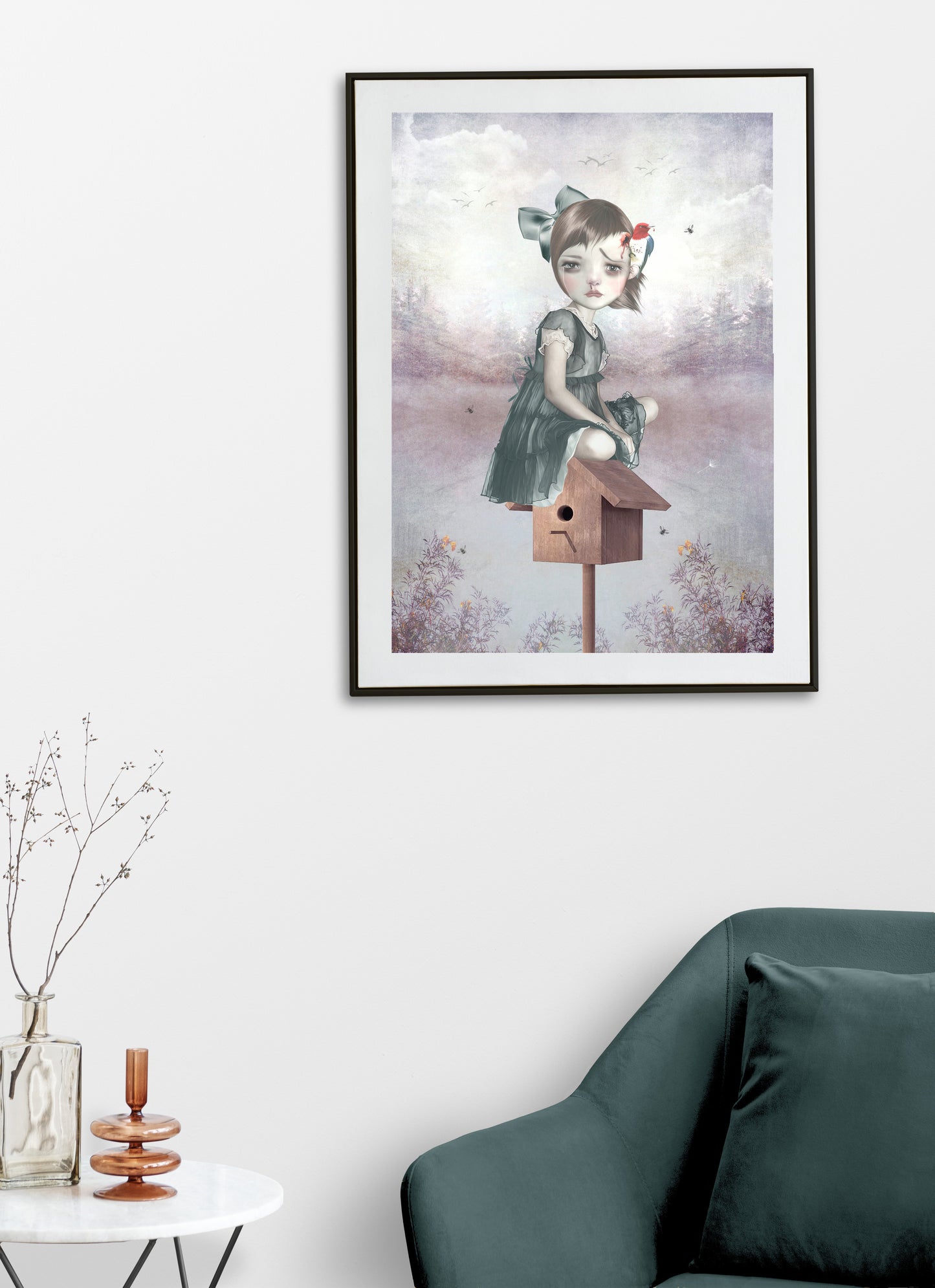 Framed surreal art print on a living room wall, showcasing a girl sitting on a birdhouse with a woodpecker pecking her head, adding a whimsical touch to the space.