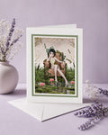 Cottagecore greeting card featuring a girl in an armchair inside a frog pond with water lilies, displayed on a lavender backdrop.