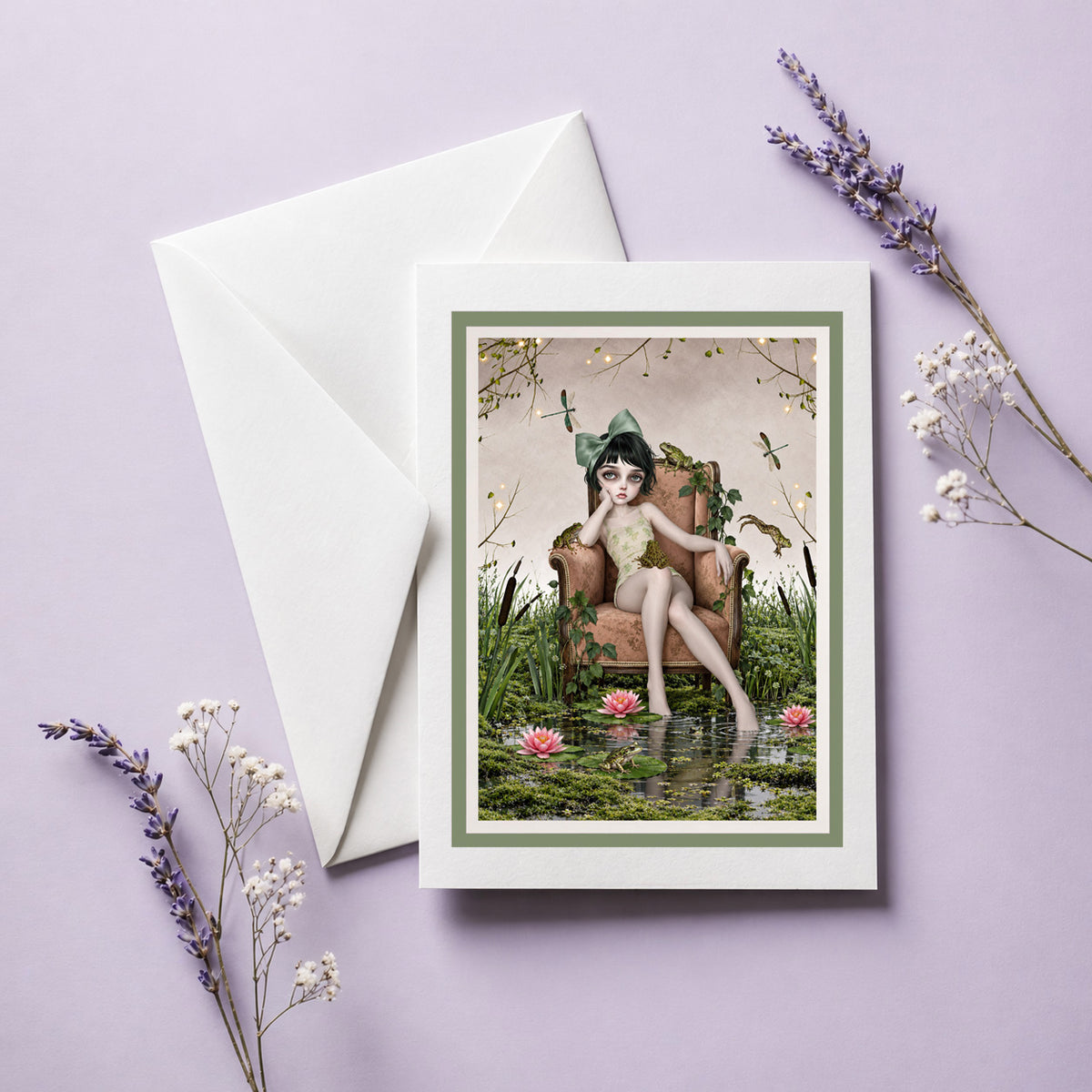 Cottagecore greeting card featuring a girl in an armchair inside a frog pond with water lilies, displayed on a lavender backdrop.