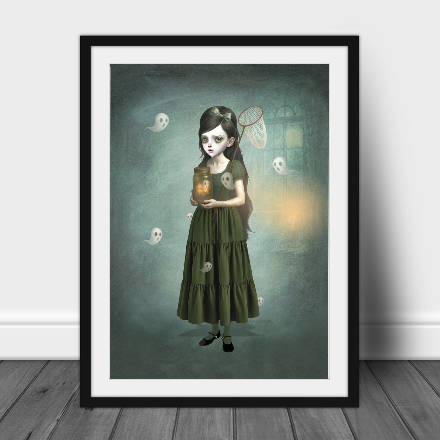 Framed artwork of a girl in a green dress holding a jar with a ghostly figure inside.