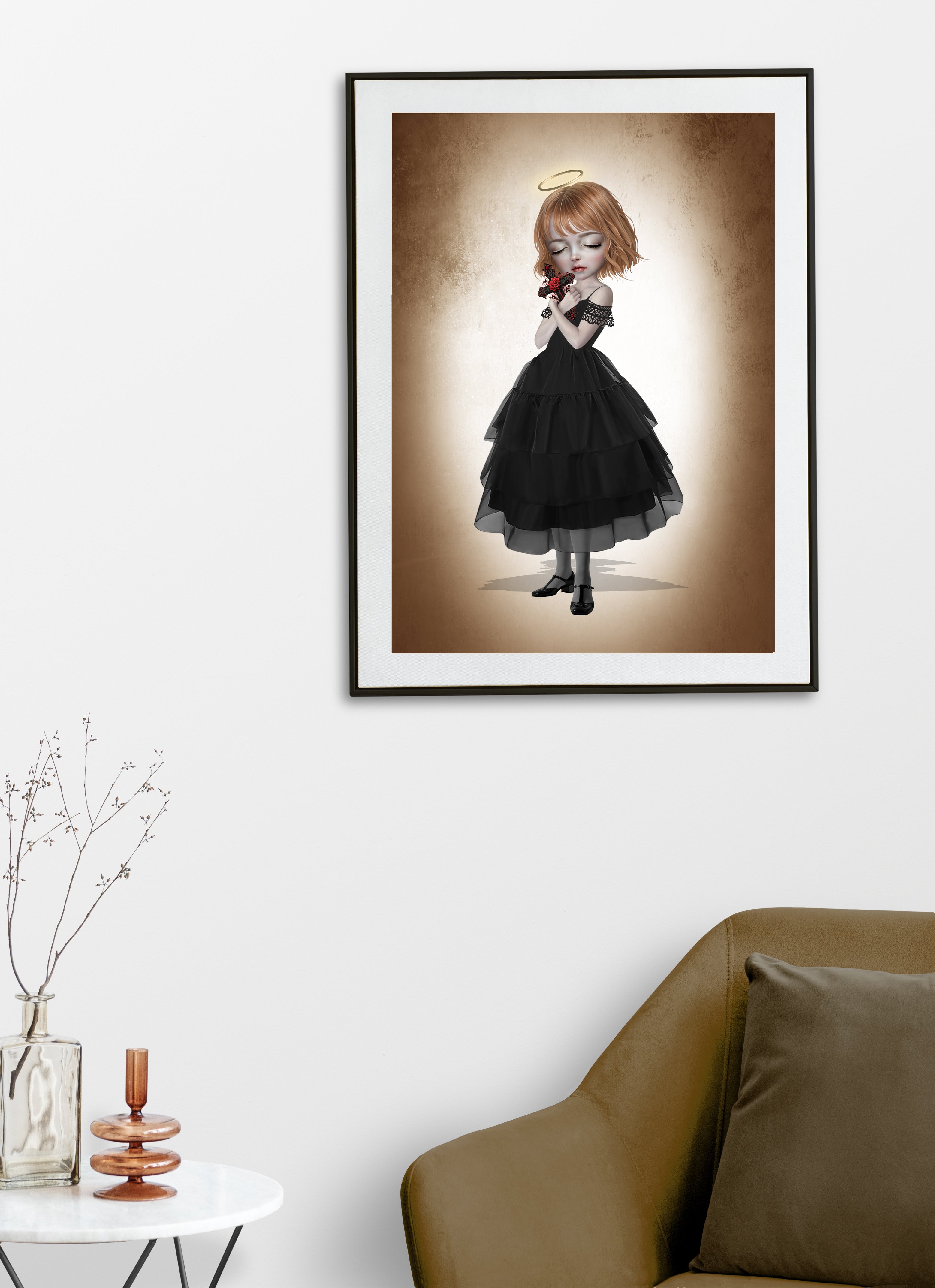 Fine art print displayed on a living room wall of a dark fantasy girl with blonde hair and a gold halo, wearing a black tiered dress and holding an ornate crucifix with a red rose.