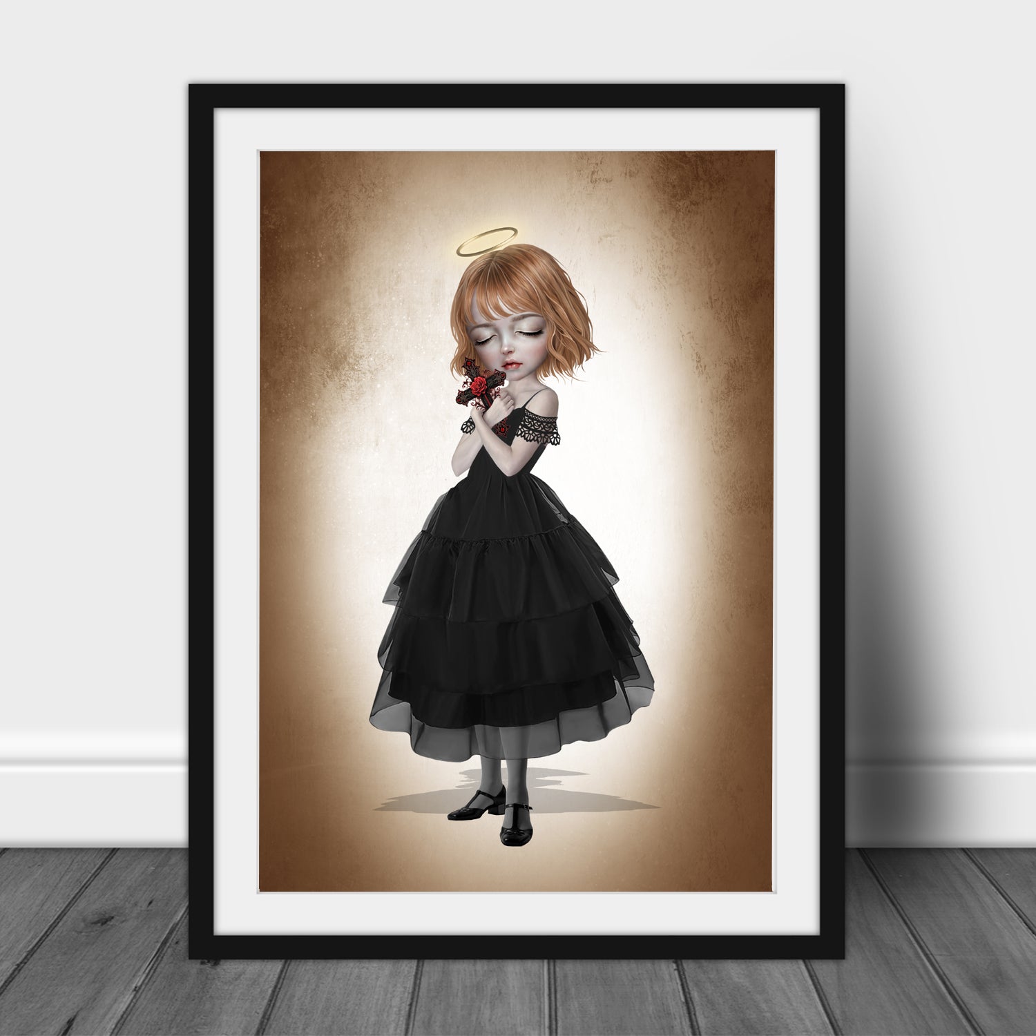 Fine art print in an A3 frame of a dark fantasy girl with blonde hair and a gold halo, wearing a black tiered dress and holding an ornate crucifix with a red rose.