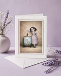 Greeting card with a vintage-style illustration of a quirky girl and piranha tank on a purple background