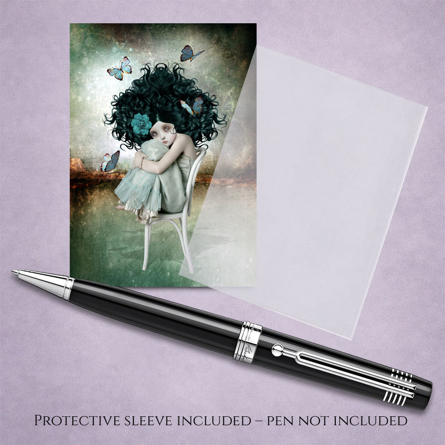 ACEO art card with a girl and butterfly illustration with protective sleeve on a purple background, accompanied by a pen.