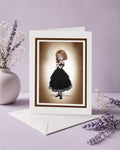Blank gothic art greeting card featuring an angelic girl holding a crucifix, displayed with an envelope and lavender sprigs.