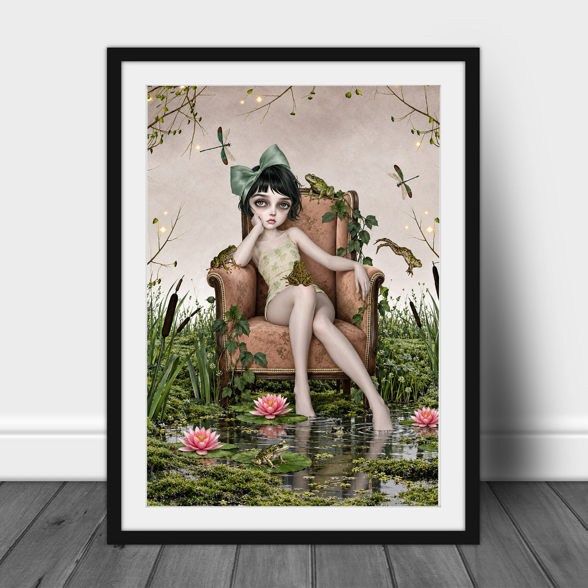 Dark cottagecore fine art print in an A3 frame featuring a girl on an armchair in an enchanted lily pond with frogs and dragonflies.