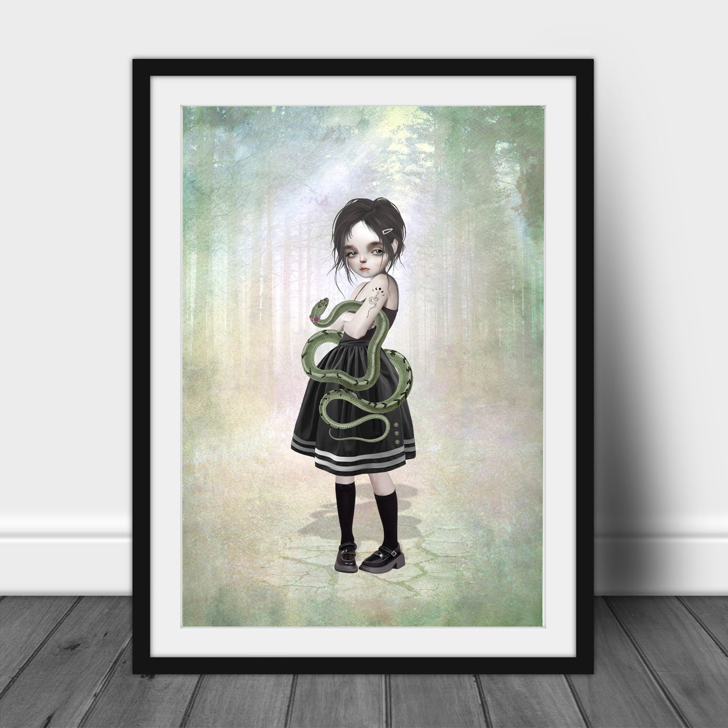 Pop surrealism art print of a girl and pet snake, in a frame, leaned against a wall.