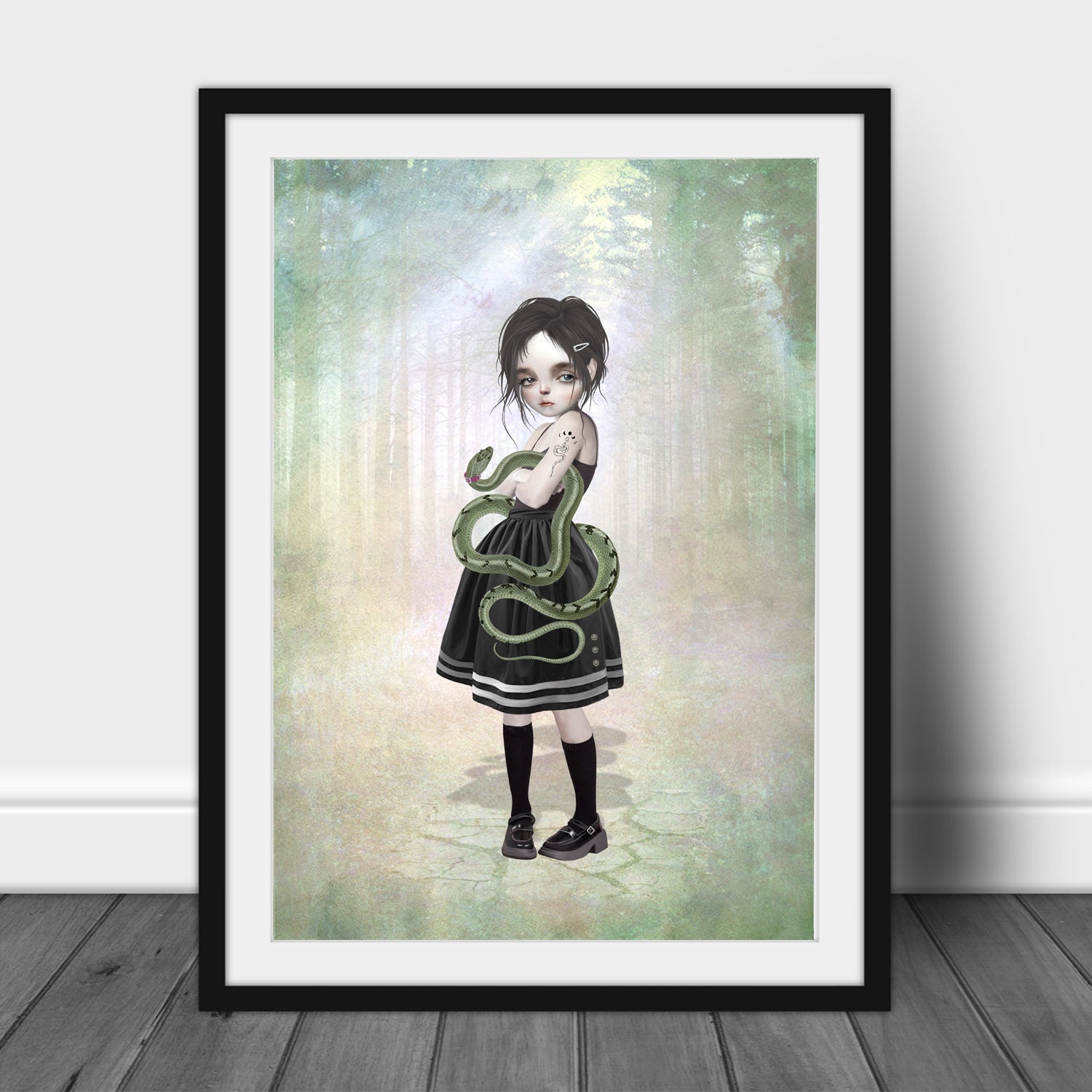 Pop surrealism art print of a girl and pet snake, in a frame, leaned against a wall.