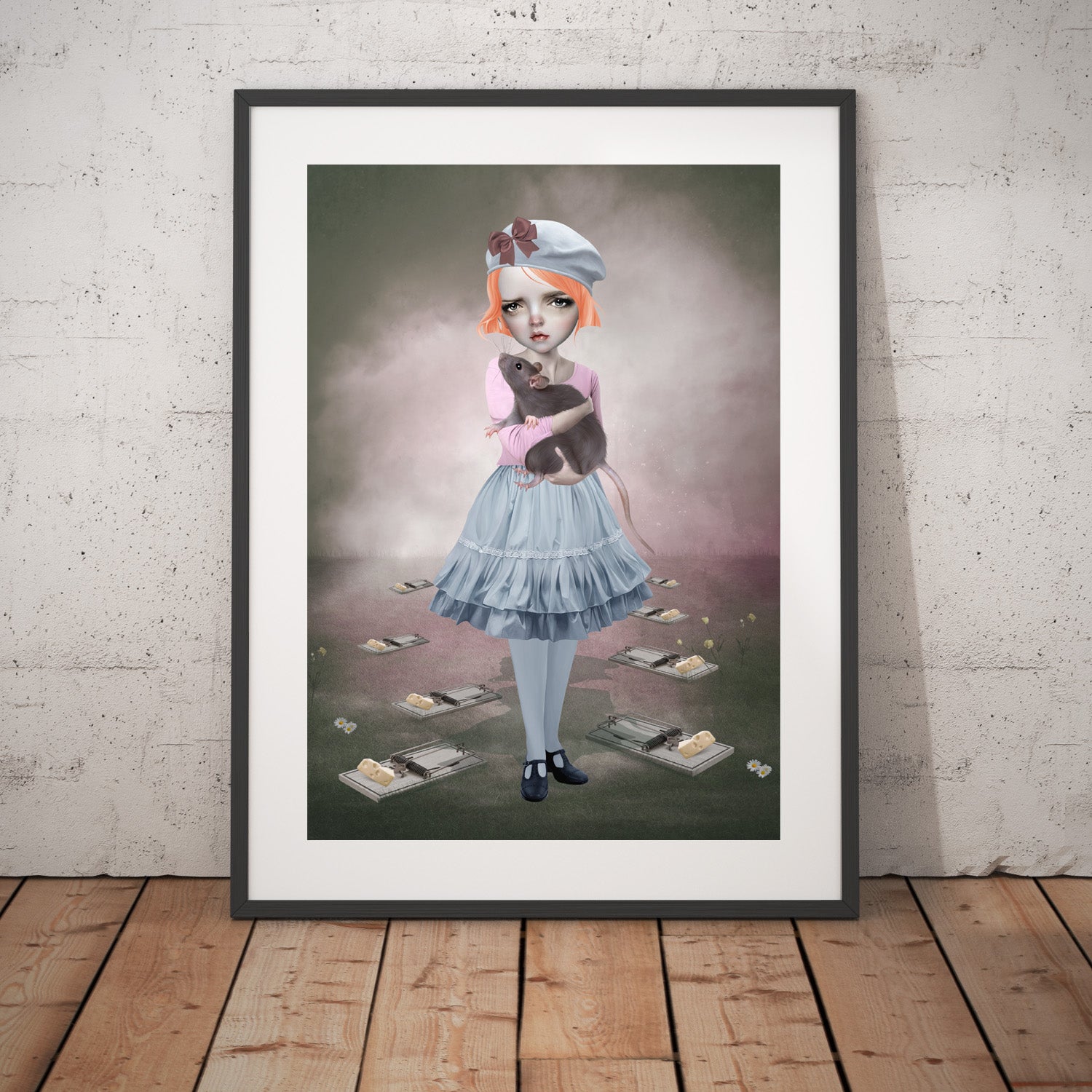 Girl and rat art print in a black frame, standing against a white wall.