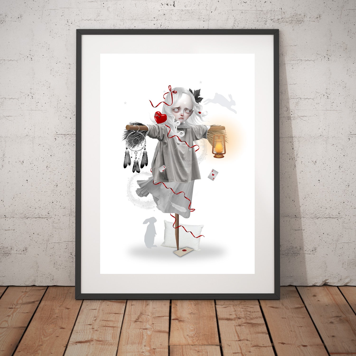 Dream Scarecrow art print in a black frame, standing against a white wall.