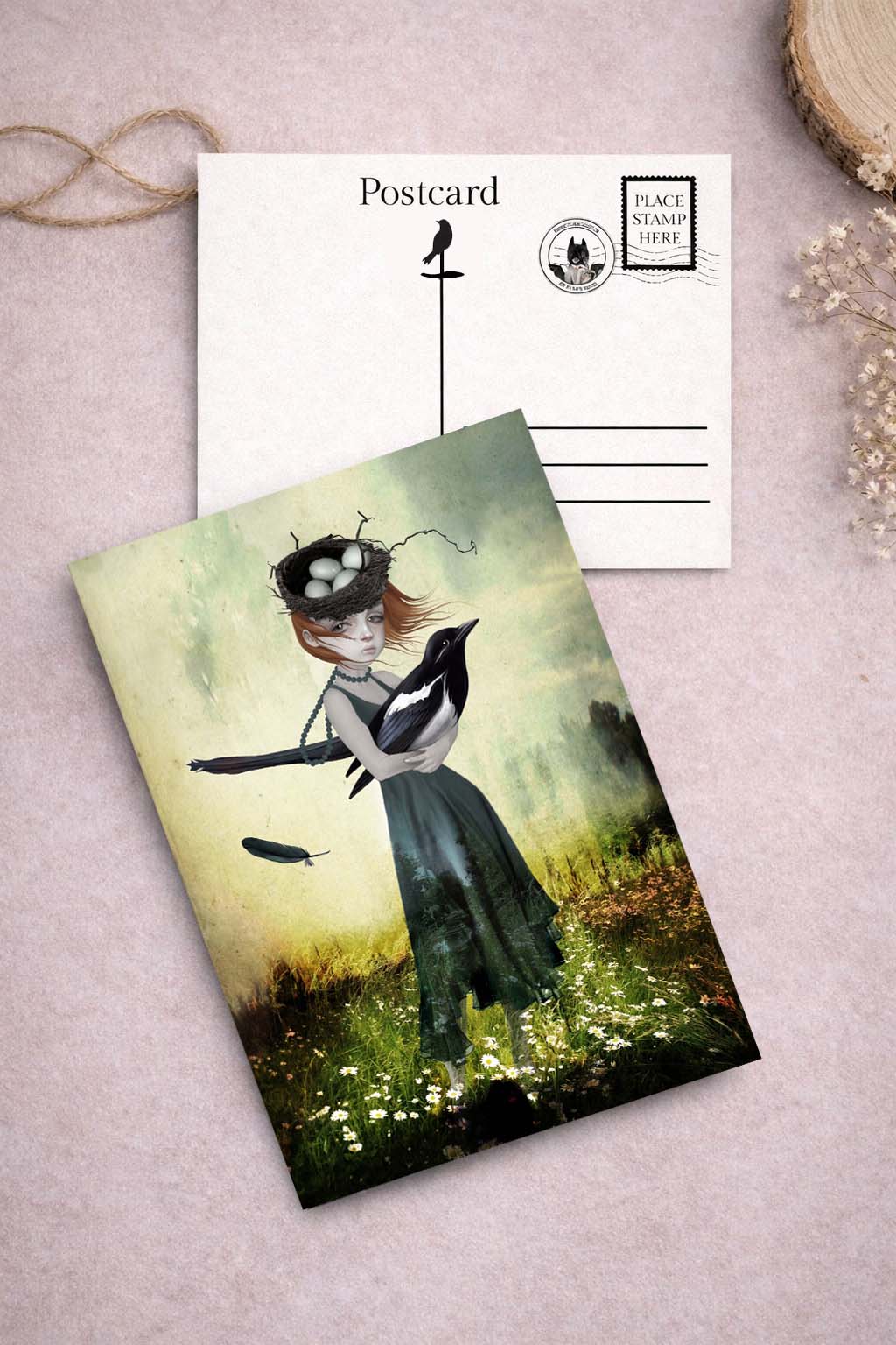 Postcard of a girl with nest on her head in a field holding an oversized magpie.