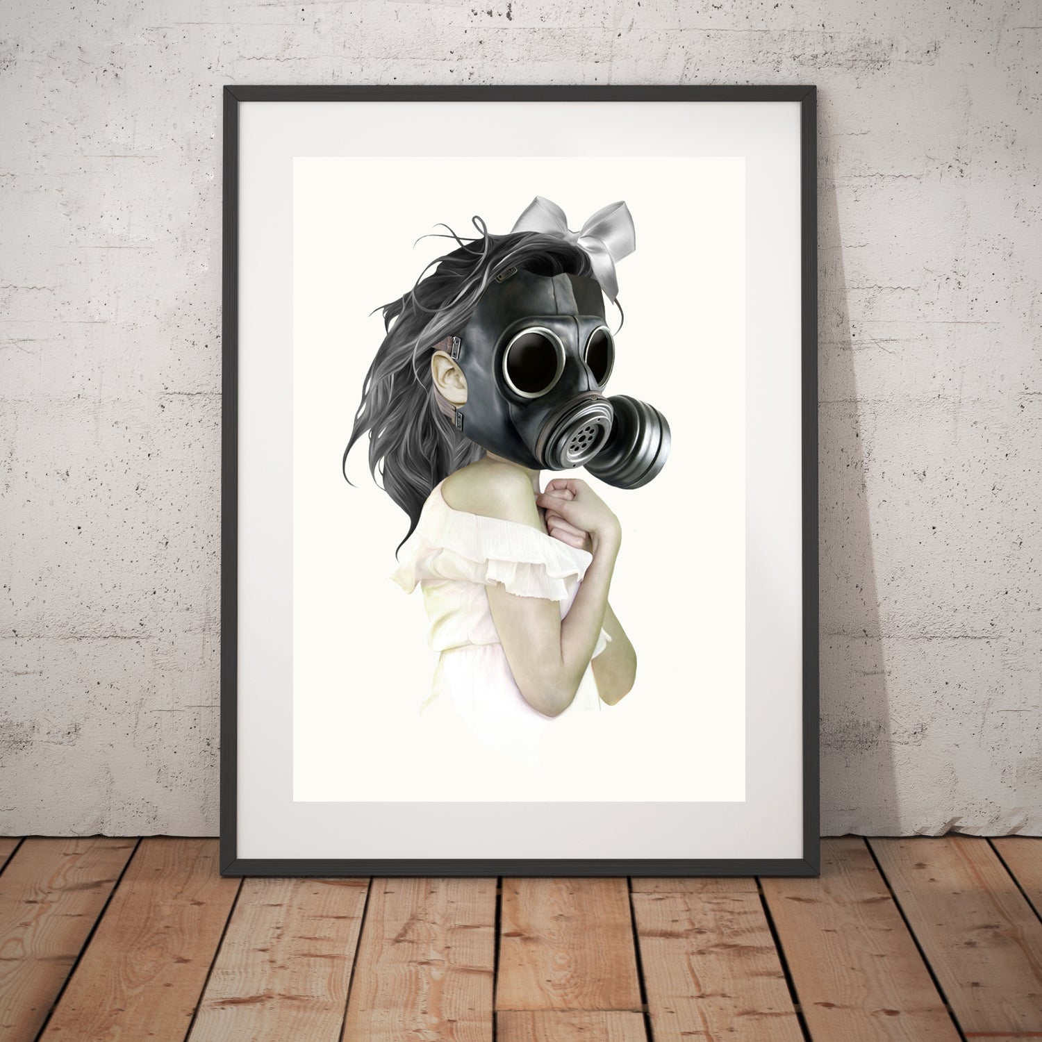 Gas mask wall art print features a girl clad in white donning a gas mask in display frame.