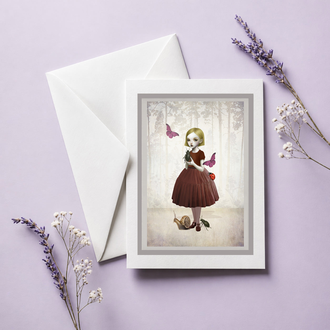 Greeting card with envelope. Illustration is a girl holding a beetle  surrounded by butterflies, Ladybird and snail.