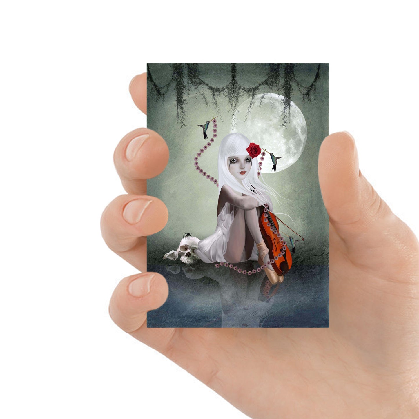 ACEO card featuring a girl with violin & skull, held in hand to show scale. A collectible gothic fantasy art piece, perfect for dark art lovers and collectors.
