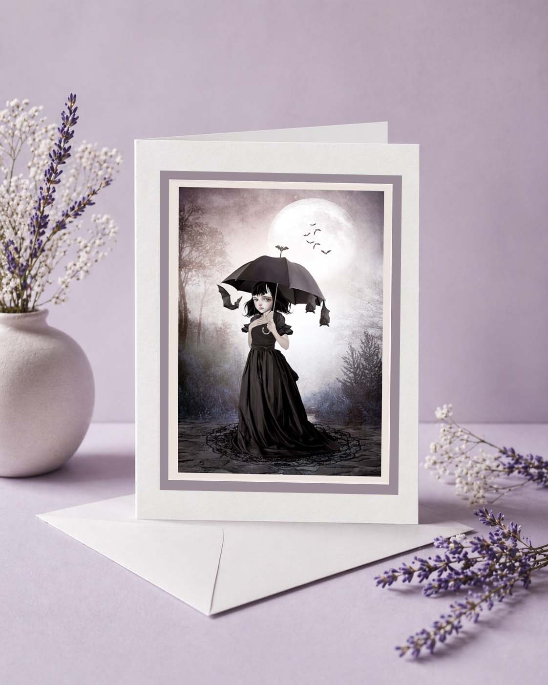 Blank gothic greeting card featuring a whimsical dark fantasy illustration of a girl with bats under a full moon. Includes a premium white envelope.