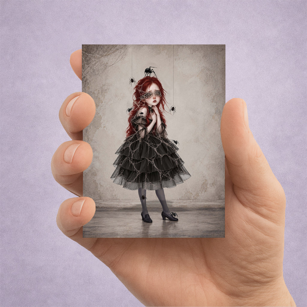 ACEO Card held in hand showing a melancholy girl with vibrant red hair wearing a dark ruffled dress and sheer tights, with intricate cobwebs over her face and black spiders hanging around her