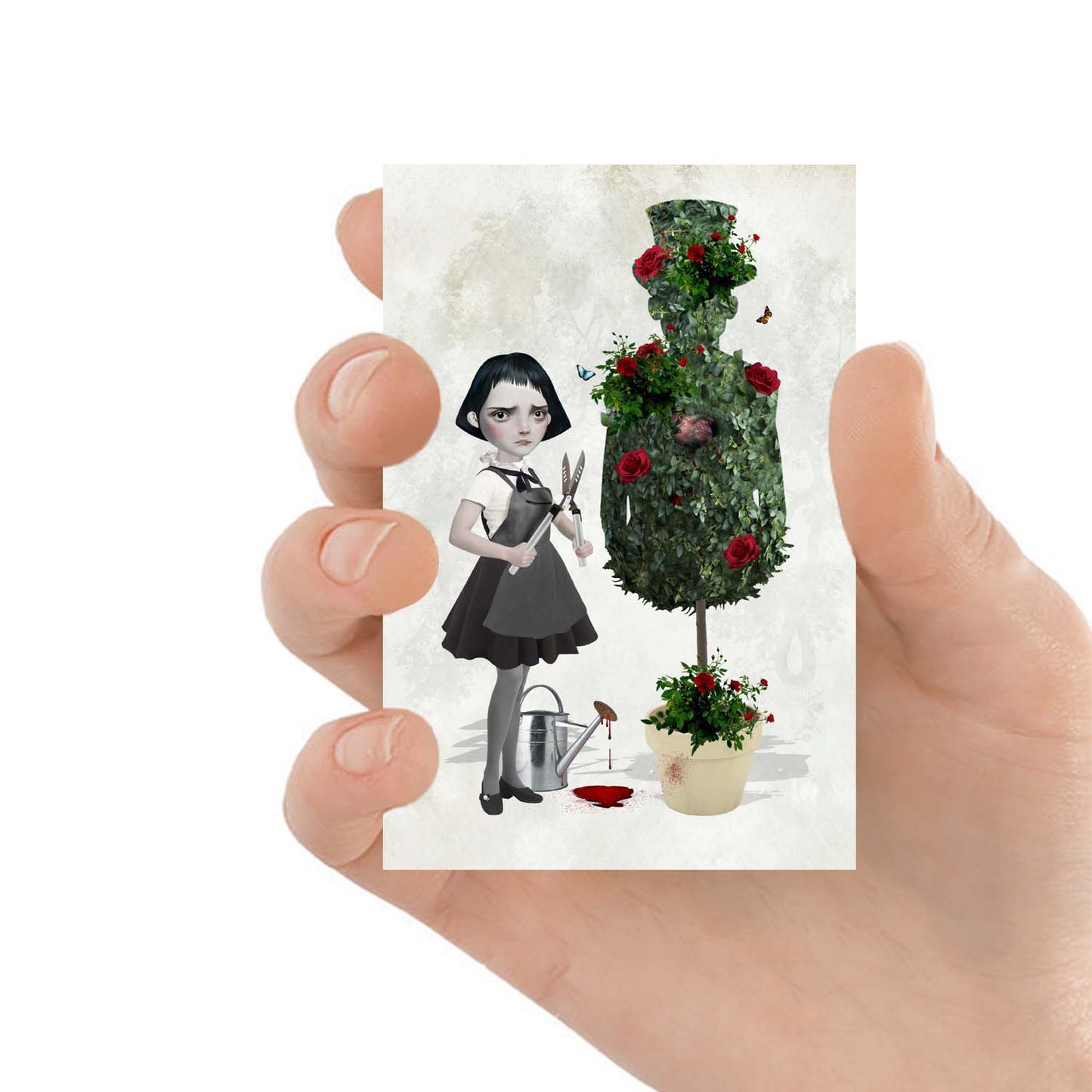 ACEO art card featuring a goth girl and topiary, held in hand to showcase the miniature size and creepy cute design.