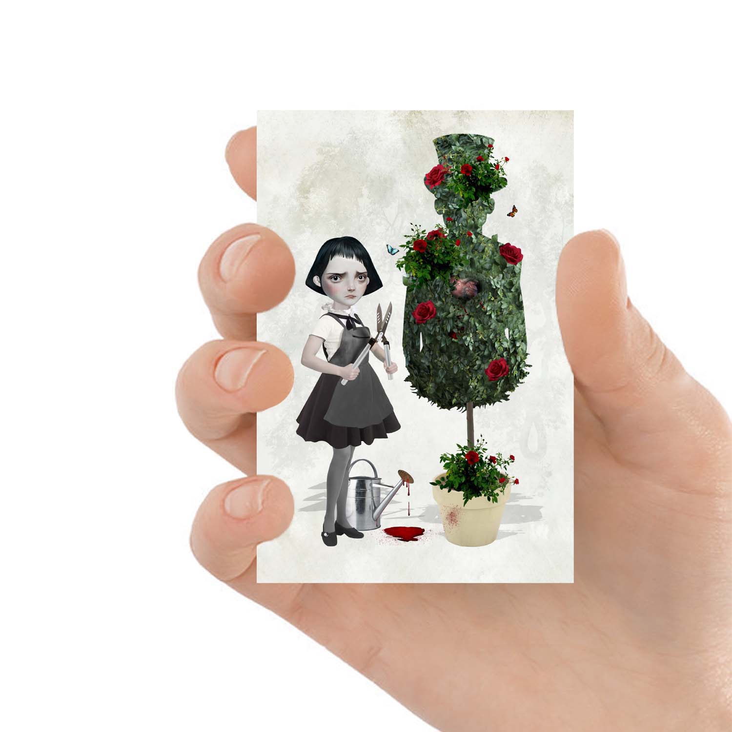 ACEO art card featuring a goth girl and topiary, held in hand to showcase the miniature size and creepy cute design.