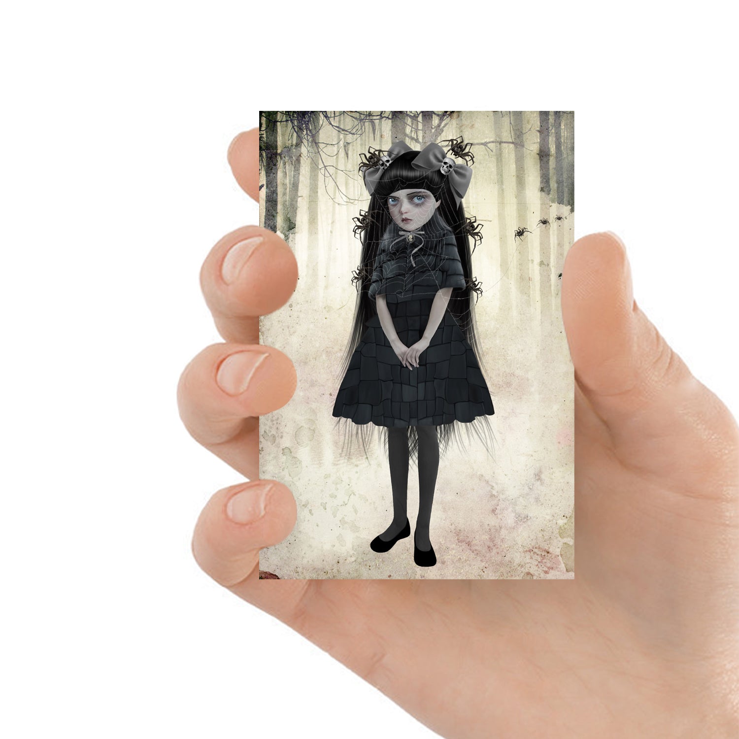 ACEO art card featuring a goth girl with spiders, held in hand to showcase the miniature size and creepy cute design.