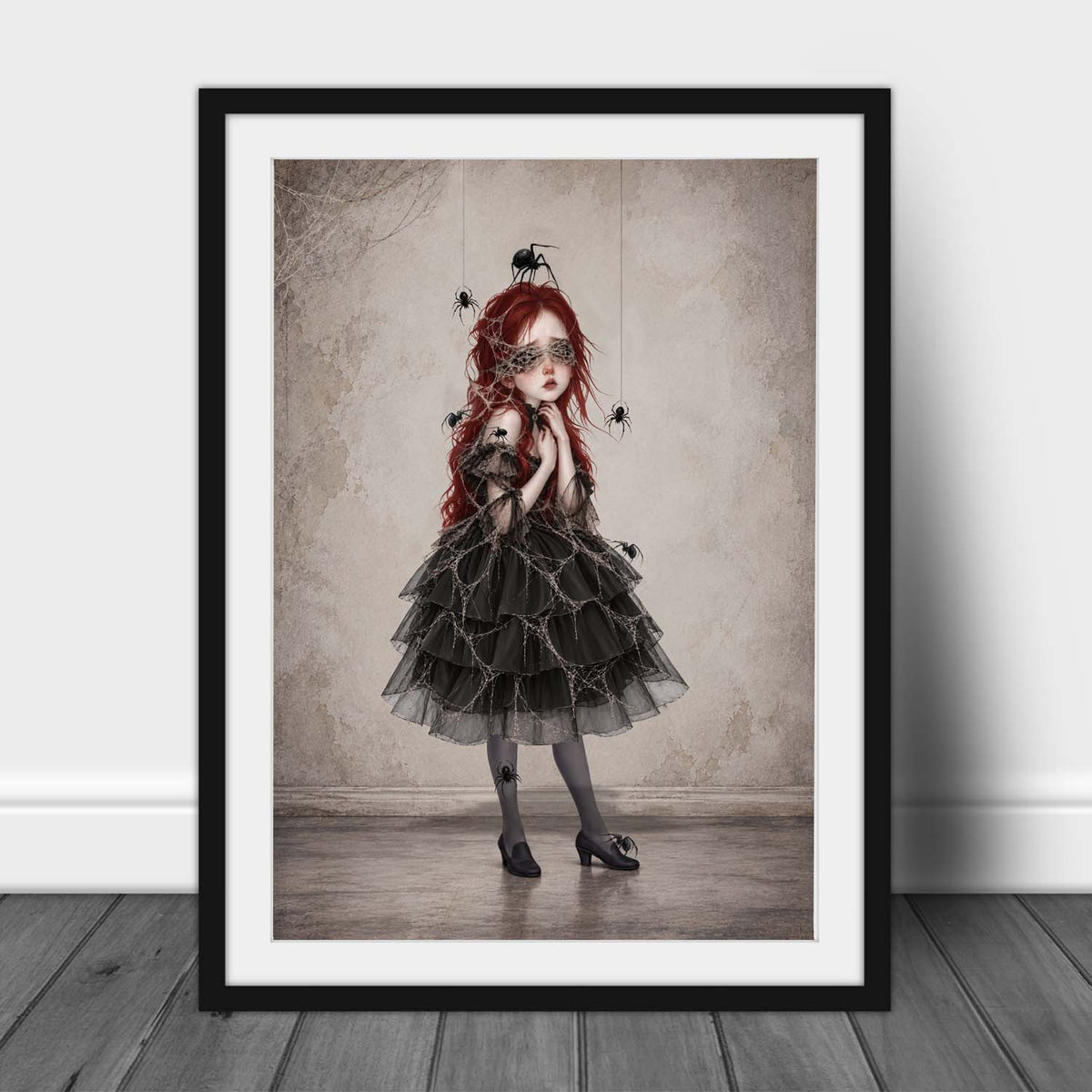 Gothic dark academia wall art print in an A3 frame featuring a surrealist portrait of a Victorian-style girl with spiderwebs over her eyes and black spiders crawling on her dress.