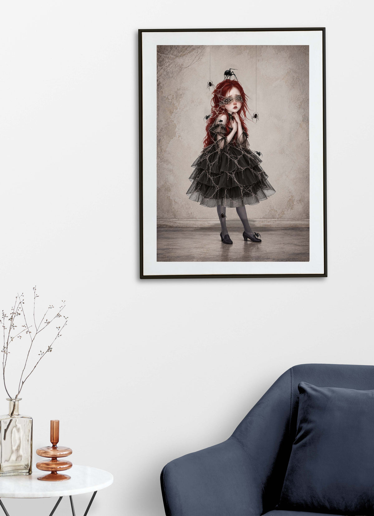 Gothic dark academia wall art print displayed on a living room wall featuring a surrealist portrait of a Victorian-style girl with spiderwebs over her eyes and black spiders crawling on her dress.