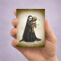 Goth girl And Voodoo Doll ACEO Card held in a hand to show miniature scale.