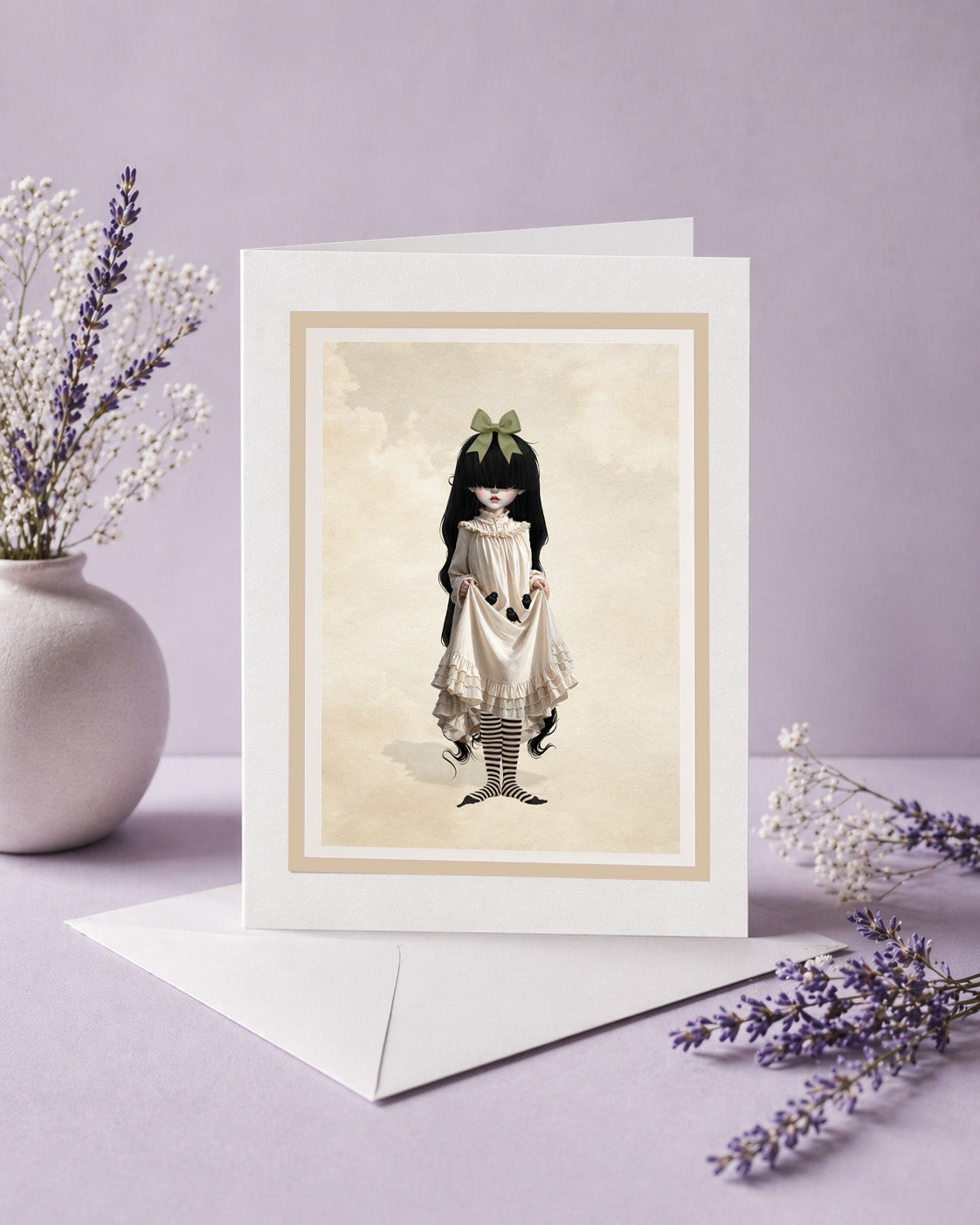 Blank art greeting card with envelope featuring a gothic Victorian girl holding baby blackbirds, styled next to a vase of dried flowers.