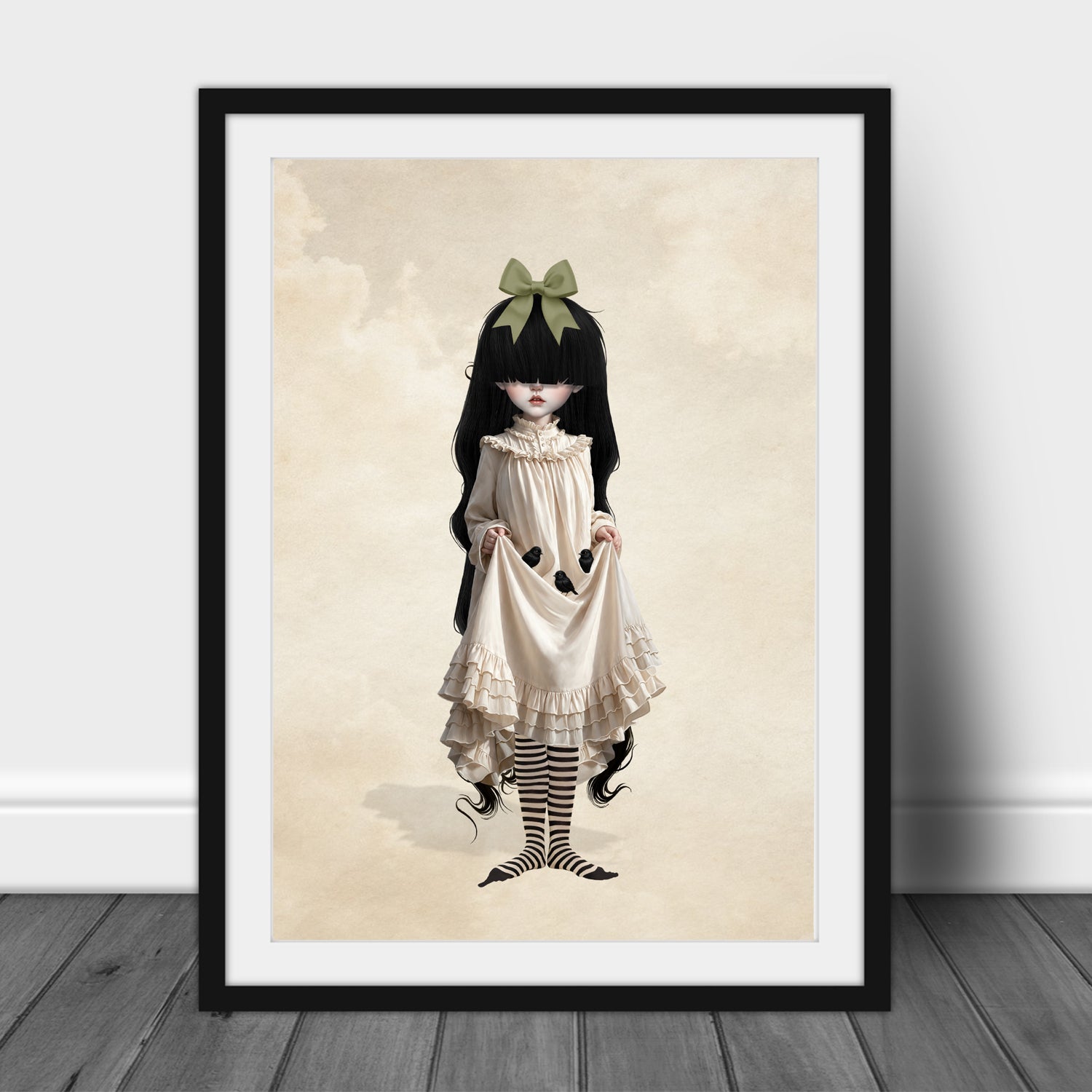 Framed A3 art print featuring gothic girl with long black hair, a green hair bow, and a cream ruffled Victorian dress holding three baby blackbirds in her skirt fold.