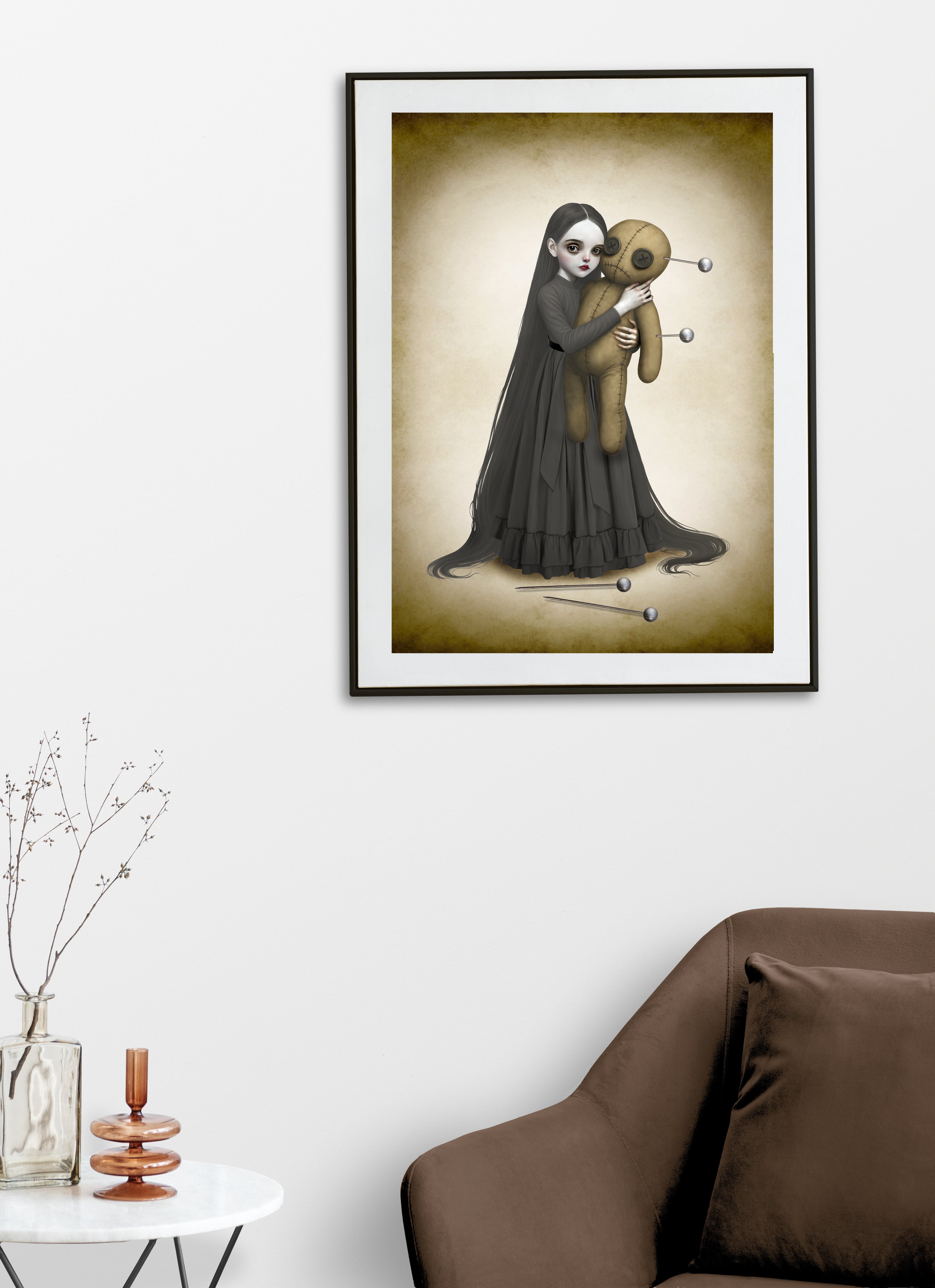 Creepy cute wall decor featuring a framed print of the She Loved It To Death illustration styled above a chair for a gothic home aesthetic.