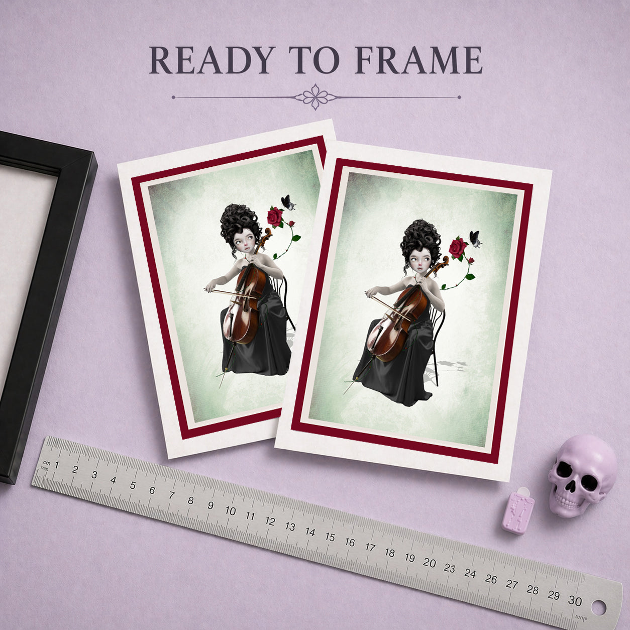 Ready to frame art greeting card of a woman playing a cello, displayed on a purple surface with a ruler and skull.