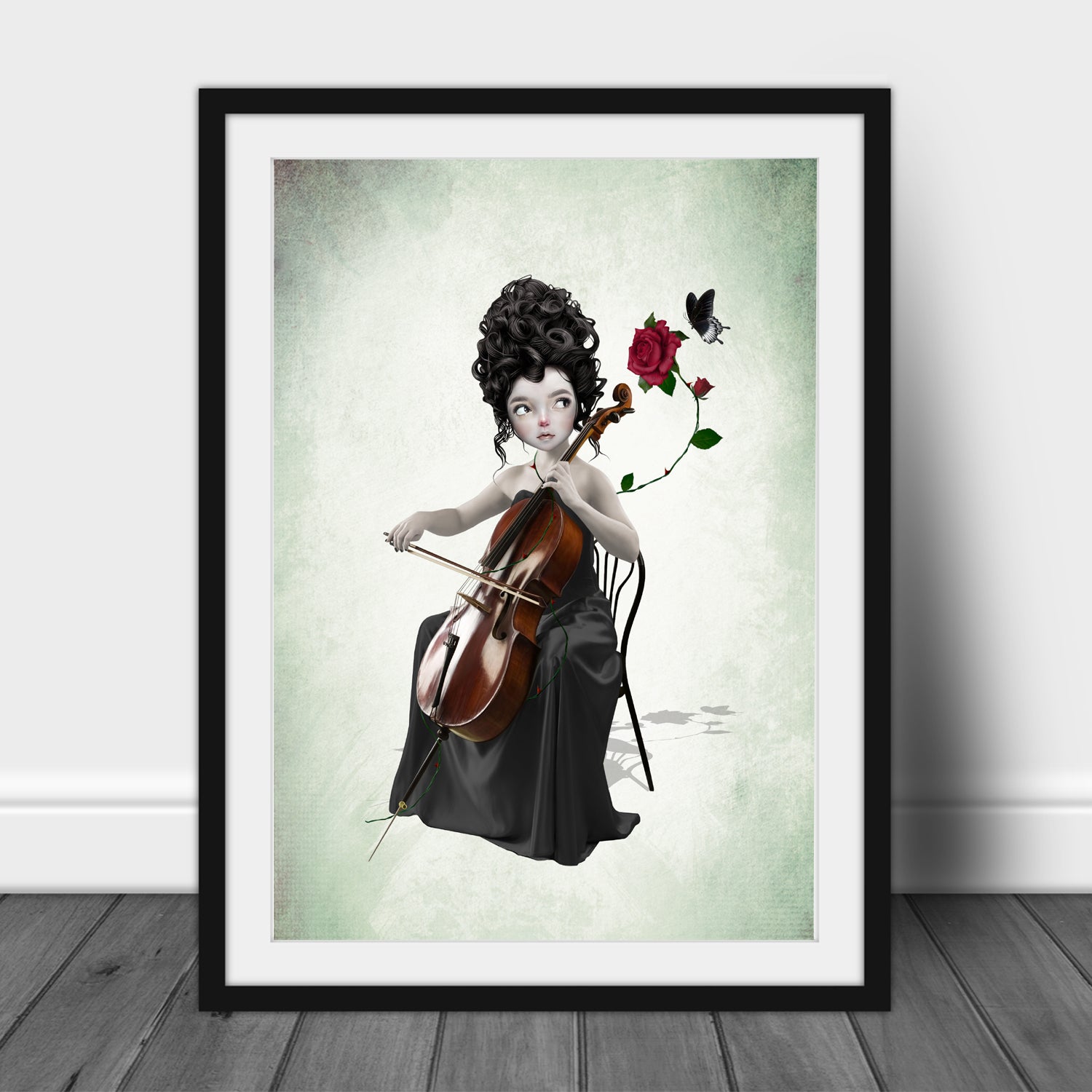 Framed artwork of a woman playing a cello with flowers and a butterfly on a light green background.