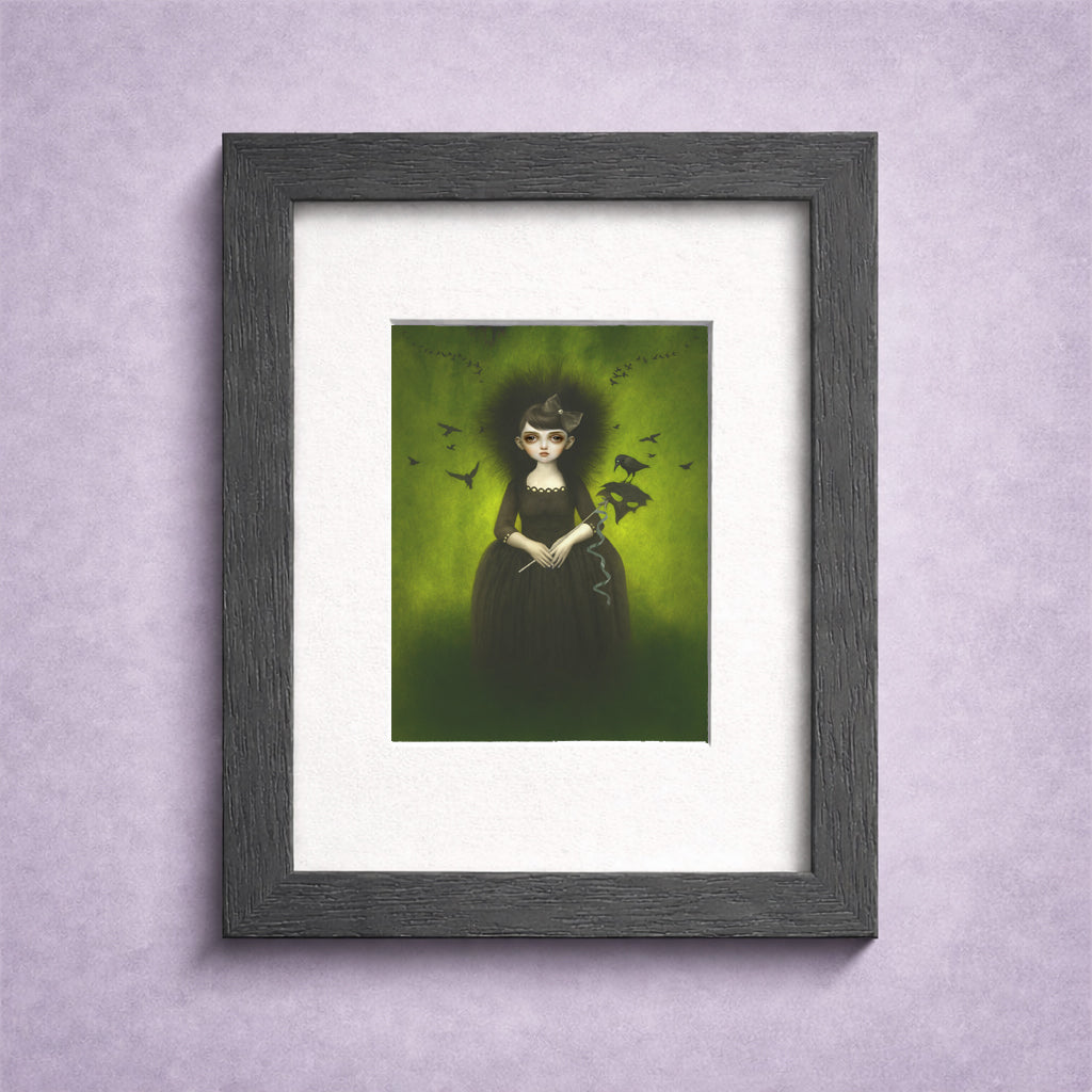 Framed ACEO artwork of a woman in a dark dress with flock of crows on a green background, displayed on a light purple wall.