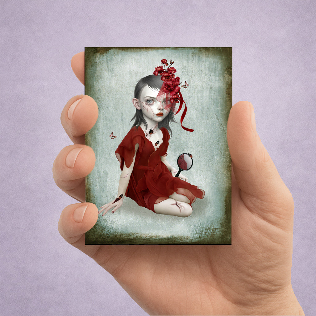 ACEO art print held in hand. Dark fantasy surrealism miniature print featuring a gothic girl in a red dress with cracked skin and bugs.