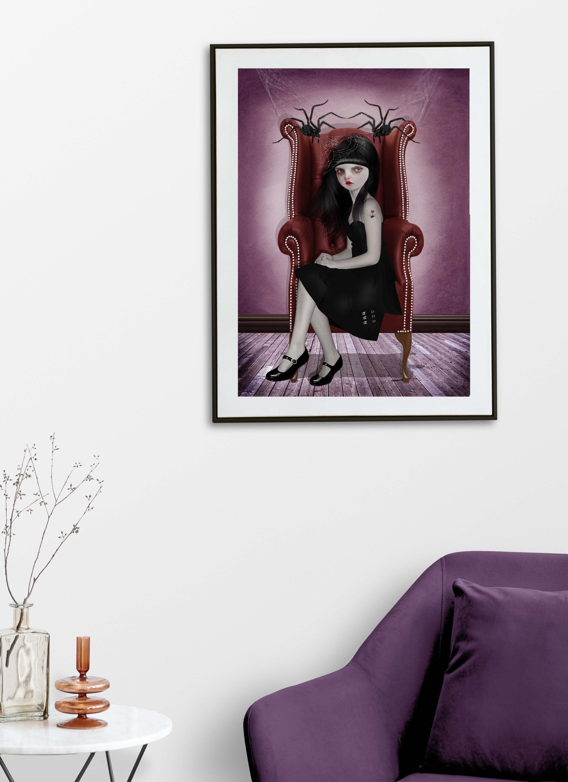 framed Miss Muffet and her pet spiders art printin a black frame on living room wall.