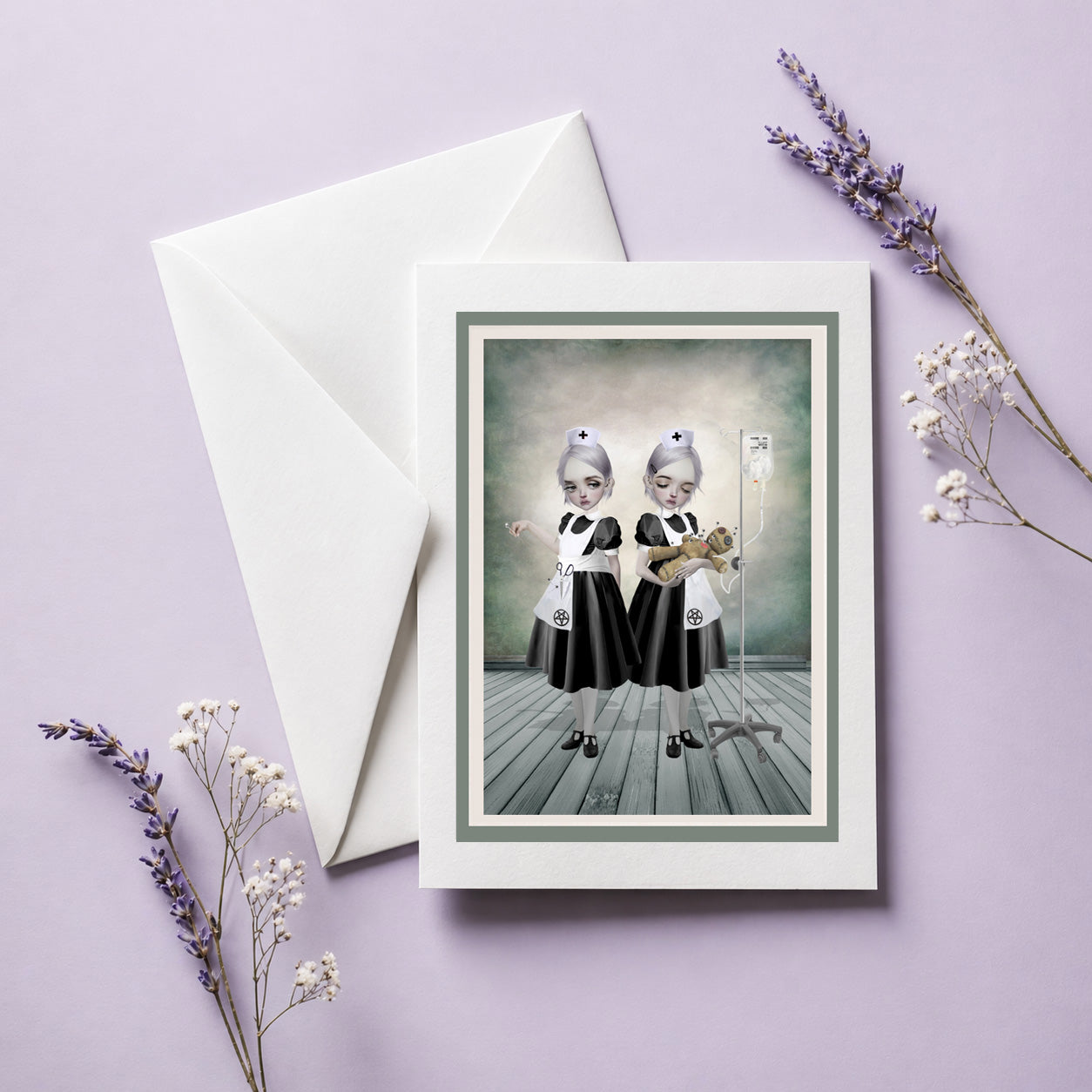 Greeting card with two goth nurses with voodoo doll .