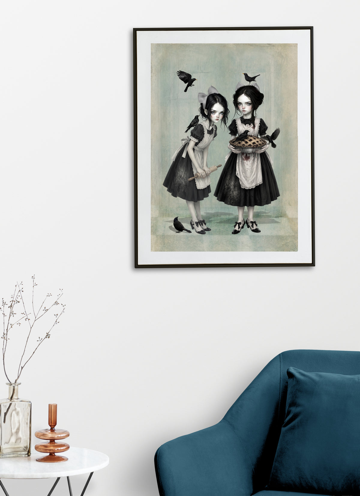 Dark cottagecore fine art print displayed on a living room wall featuring twin gothic girls in aprons holding a pie and rolling pin, surrounded by blackbirds.
