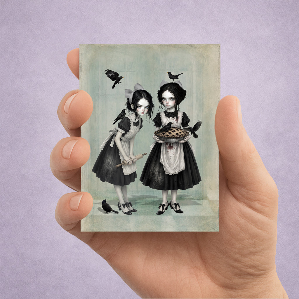 Miniature 2.5x3.5 ACEO art card displayed in hand, featuring twin gothic girls with blackbirds and a pie in a dark cottagecore style.