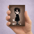 ACEO mini art trading card held in hand featuring a gothic girl holding a flute with white mice perched on her dress and sheet music at her feet.