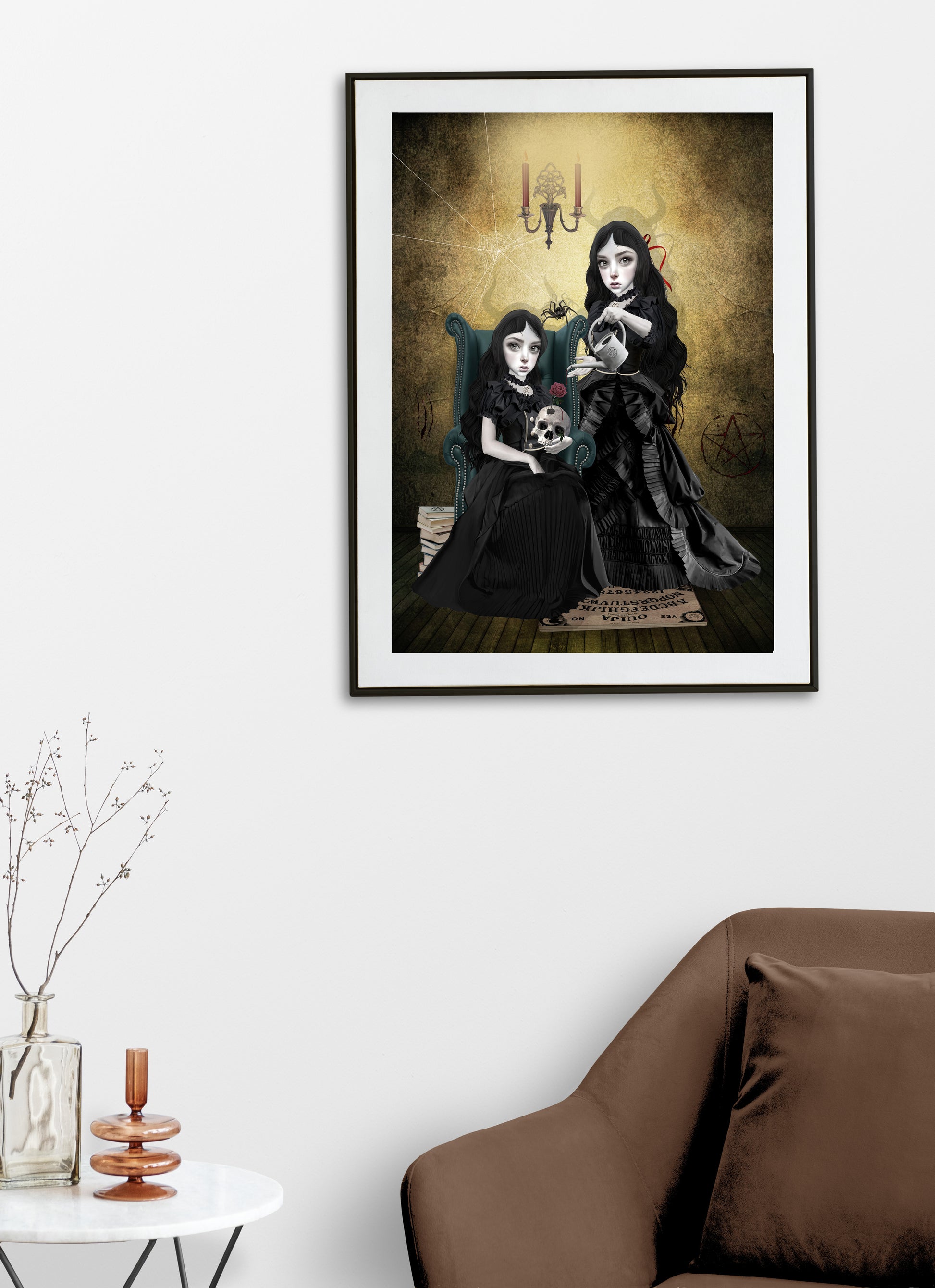 Gothic sister witches art print hanging on the wall of a modern living room. Perfect for adding a creepy cute touch to gothic or alternative home decor.