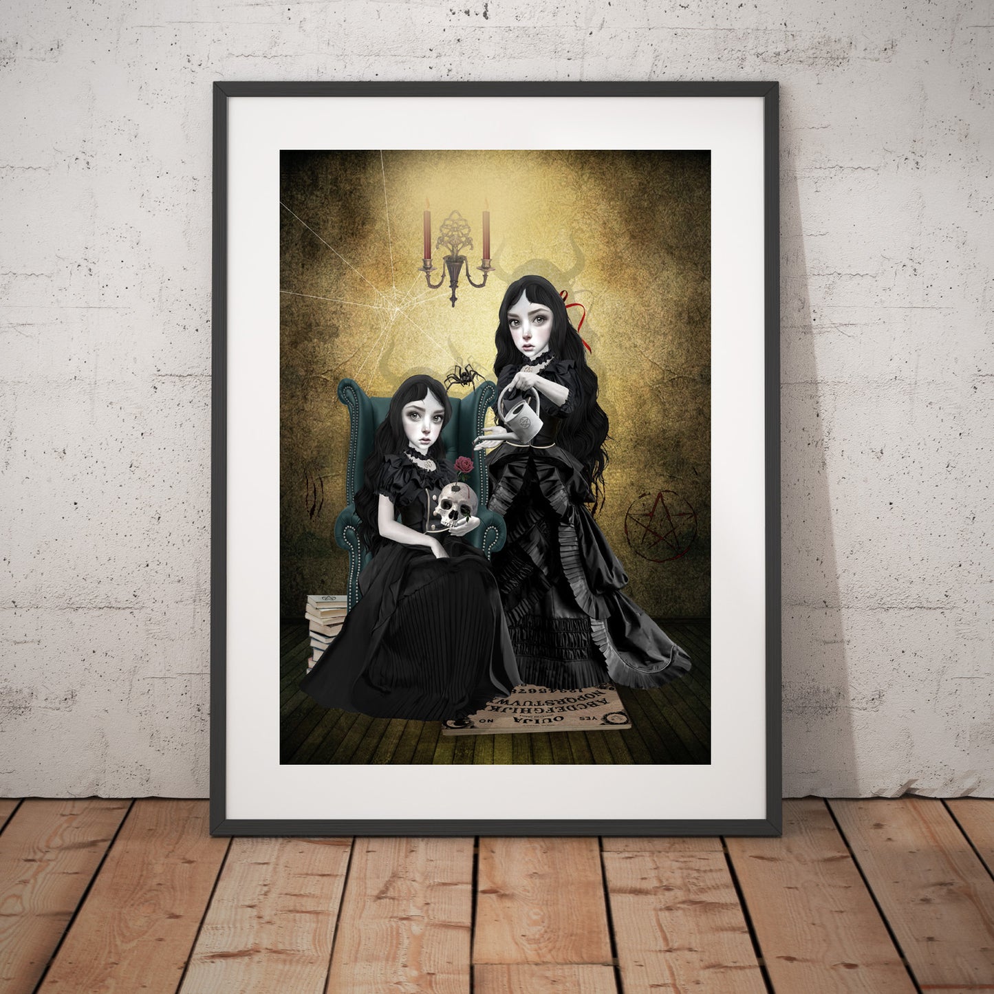 Gothic sisters at witching hour art print in a black frame, standing against a white wall.