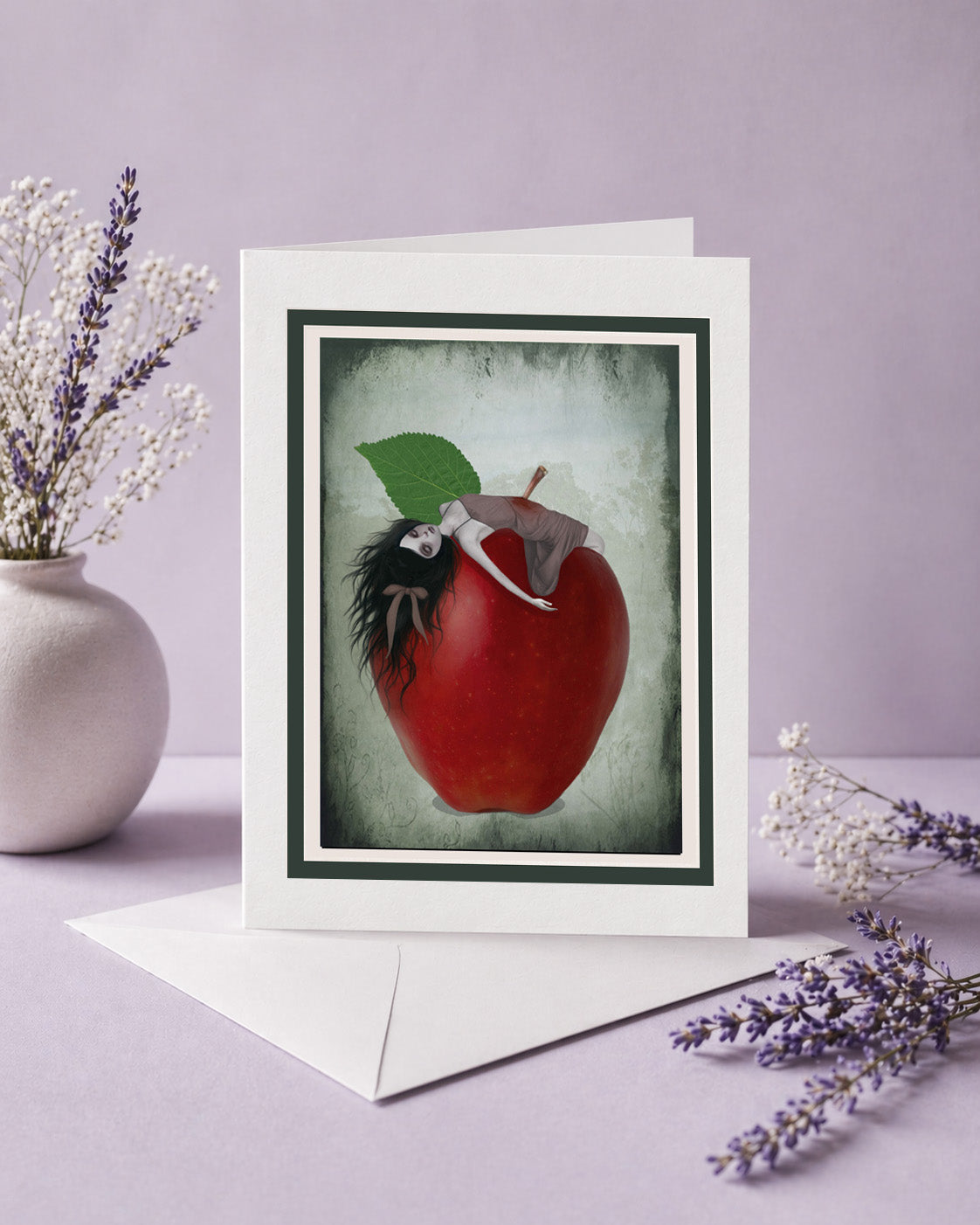 Gothic greeting card with Snow White impaled on a red apple illustration on a purple background