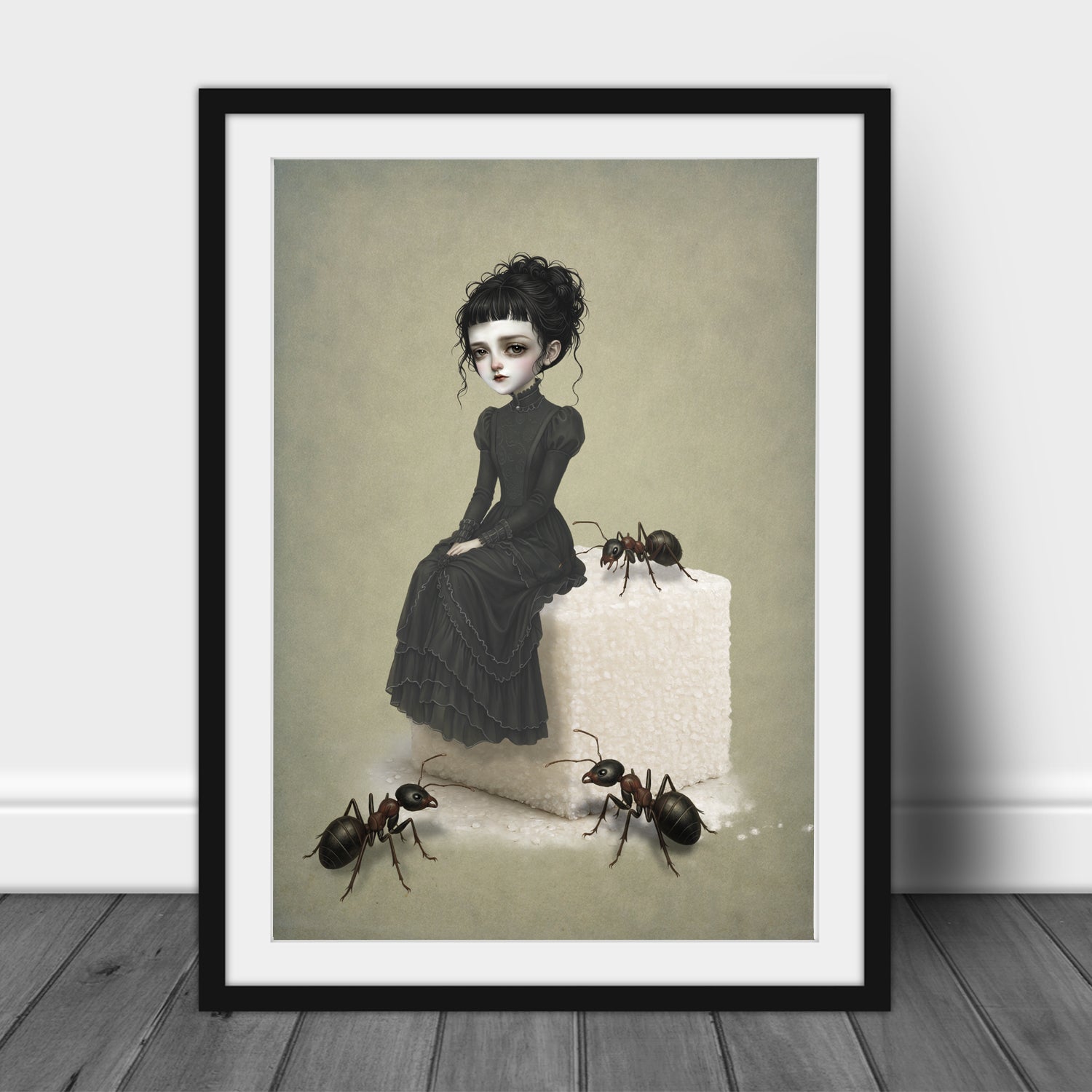  A dark whimsy pop surrealism art print in an A3 frame featuring a melancholy young woman in a black Victorian ruffled dress sitting on top of a giant white sugar cube, surrounded by three large, realistic ants on a muted green background.