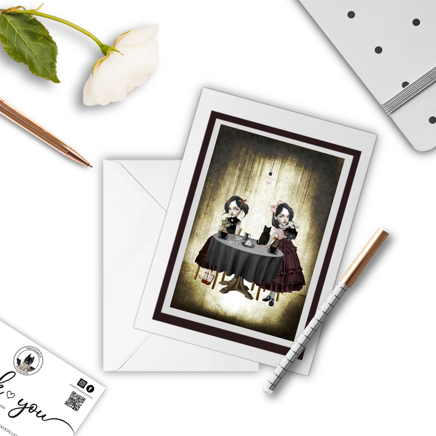 Gothic Tea Party Art Greeting Card.With a pen and other stationary items arranged around it.