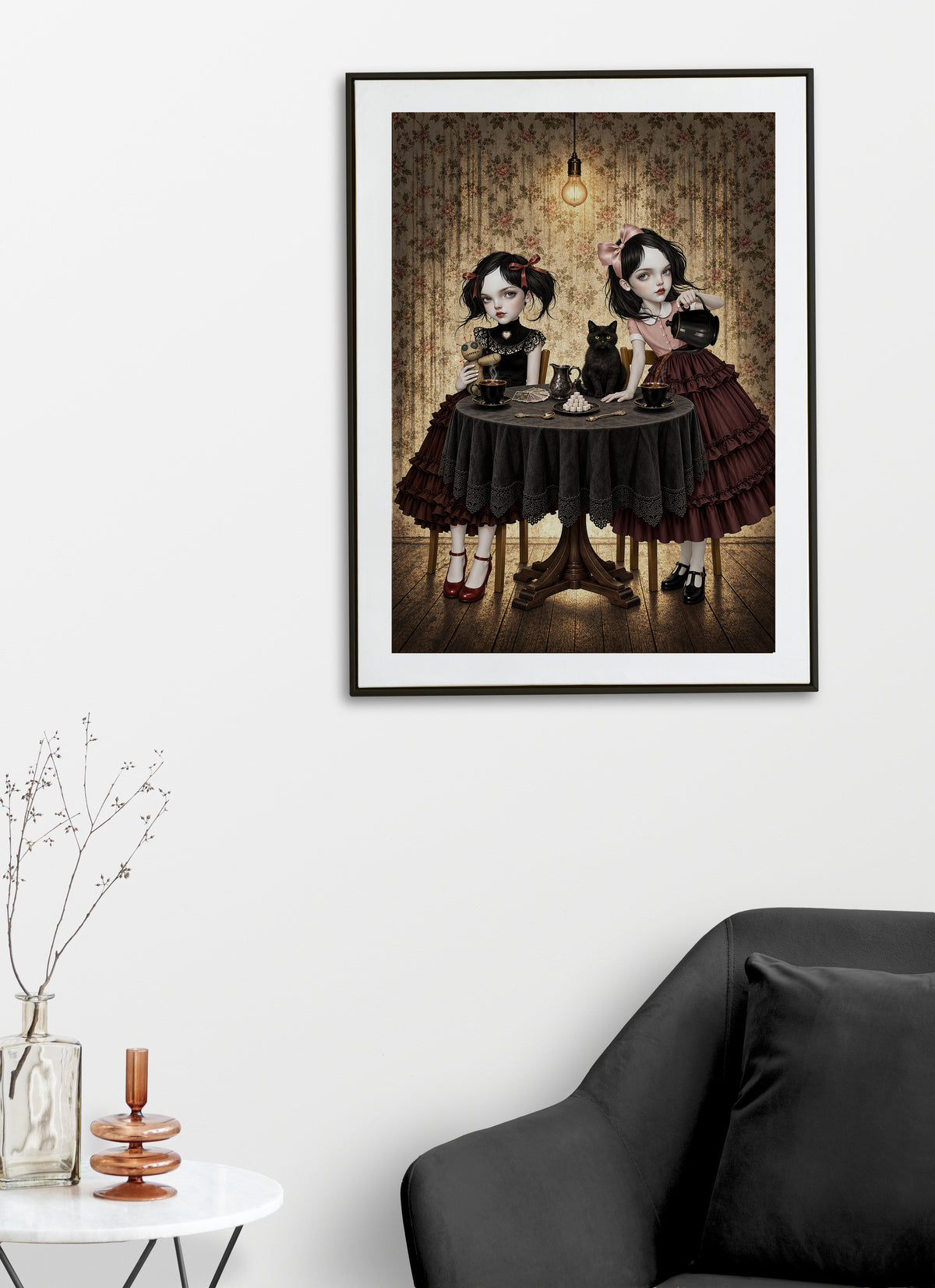 Gothic Tea Party Art Print on display on a living room wall featuring two gothic girls sitting at a round wooden table having a tea party with a black cat, a voodoo doll, and tarot cards.