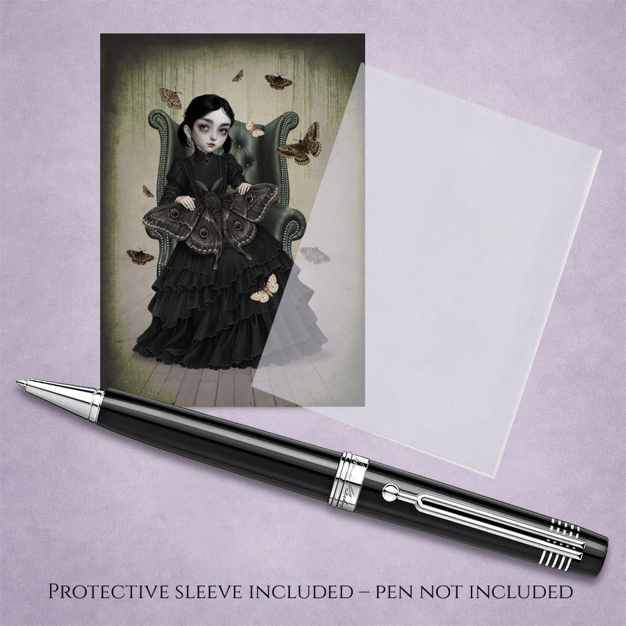A 2.5x3.5 inch ACEO art trading card With protective sleeve featuring a gothic girl in a black Victorian dress sitting in an armchair with giant moths.