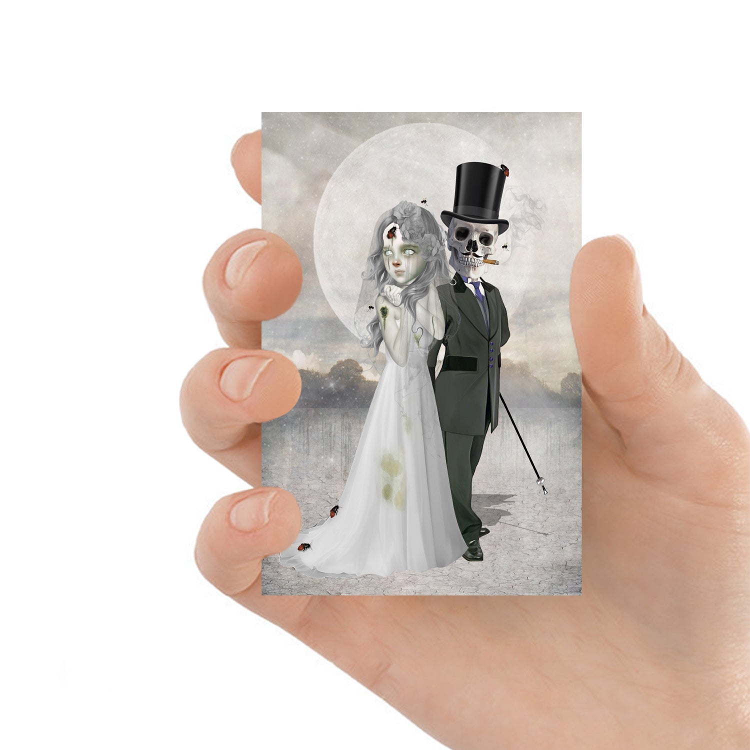 ACEO art card featuring a skeleton groom and zombie bride, held in hand—creepy cute gothic art style with dark, whimsical elements.