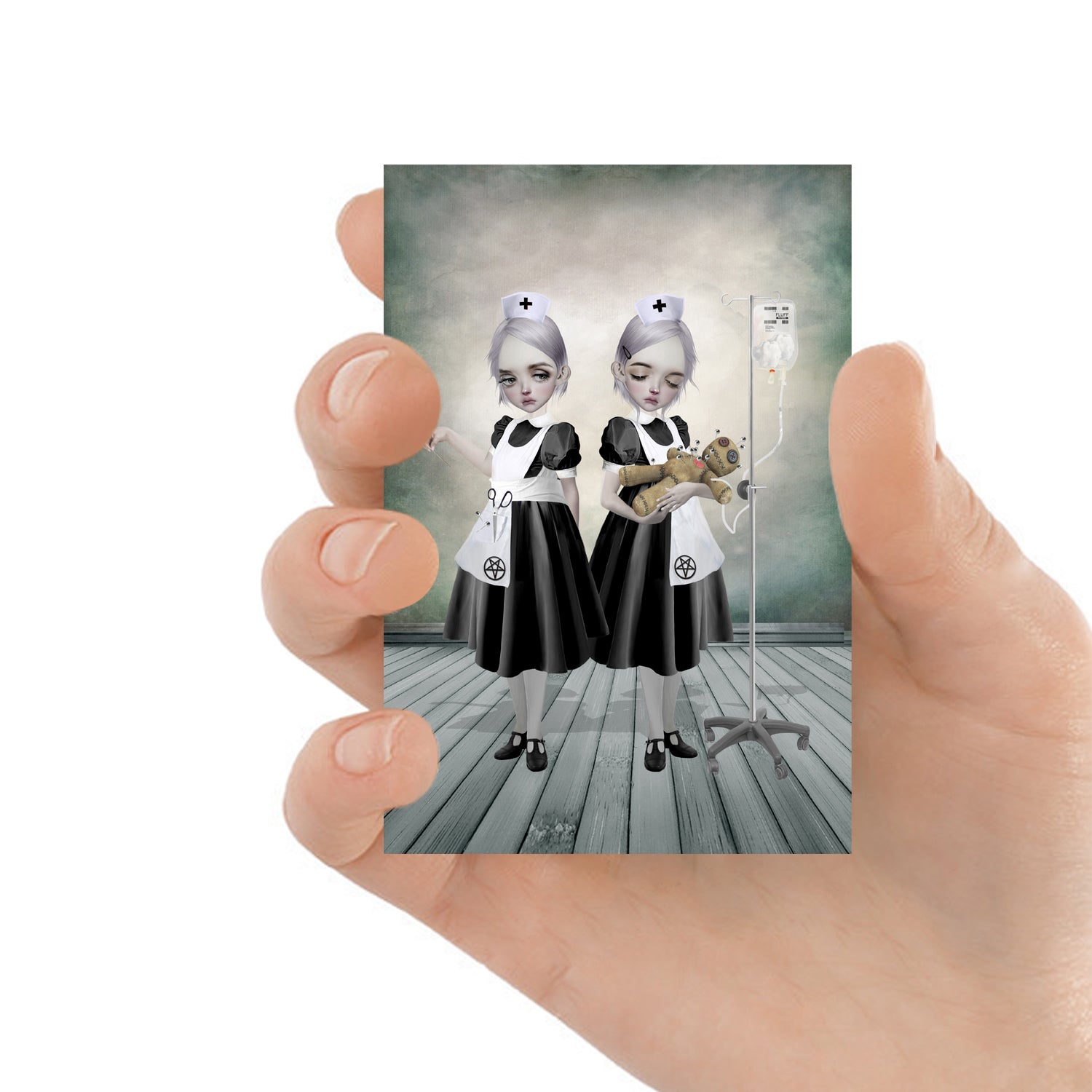 Creepy cute ACEO features two eerie yet charming nurses tending to a voodoo doll. One inserts pins with precision, while the other administers an IV of fluffy stuffing.