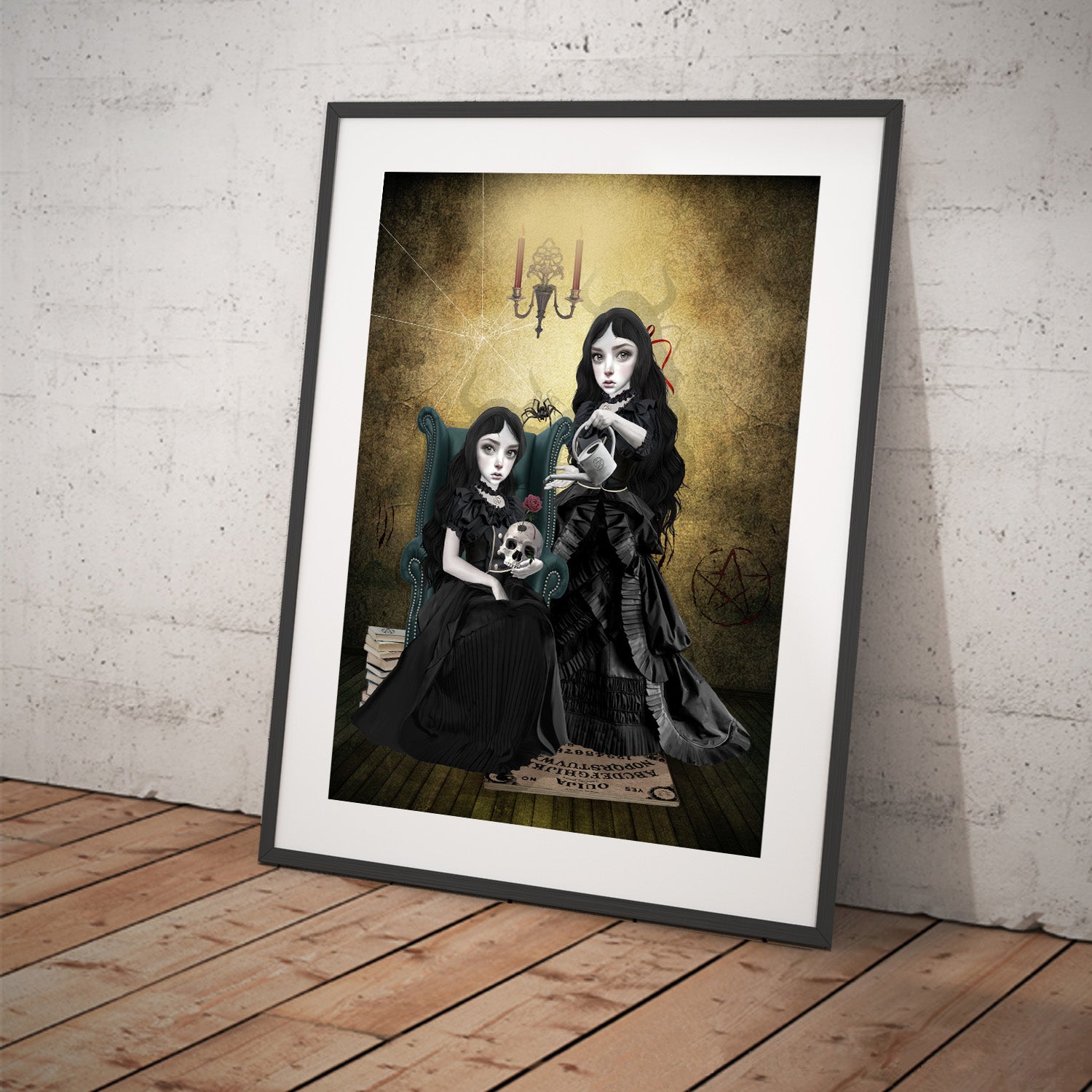 Art print featuring gothic sister witches. Displayed in a tilted frame for a stylish presentation. Perfect for creepy cute or witchy-themed decor.