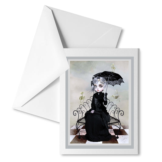 Gothic greeting card features a Gothic Victorian lady dressed in mourning attire, grieving for her beloved birds. But in a surreal twist, the birds have returned in skeletal form