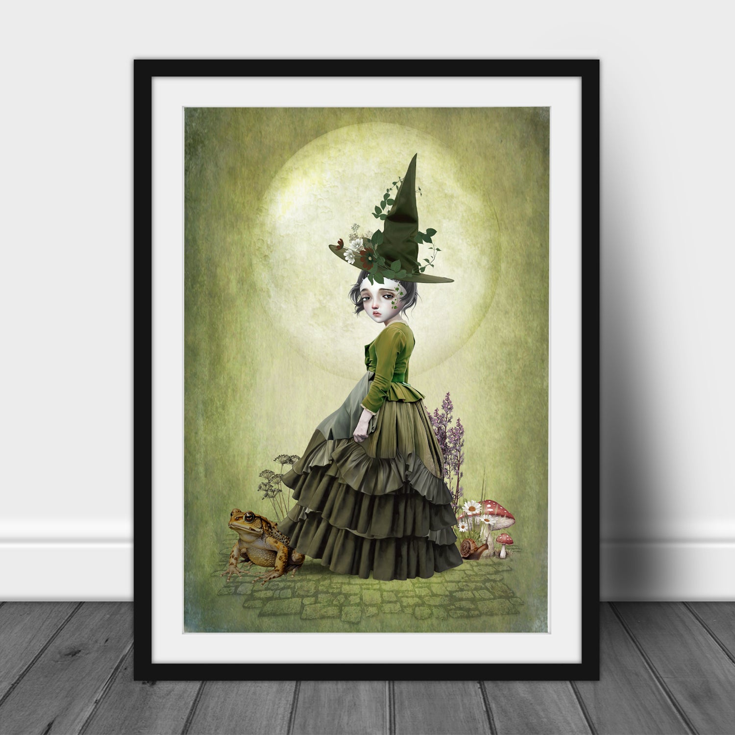 Framed artwork of a witchling with a giant toad under a full moon.